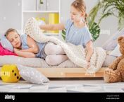 girl sleeping in bed and her sister putting a blanket on her in a white room with a yellow cube and teddy bear mn8npk.jpg from sister sleeping in bed room and brother sex