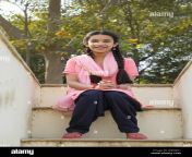 smiling young village girl sitting on the steps of her house leading to the terrace rb9mk1.jpg from gaon ki lady