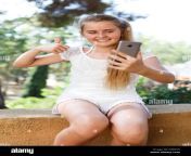 cheerful teen girl making selfie with phone in summer green park at sunny day r2bc95.jpg from young selfie twens
