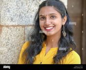 beautiful indian girl with stylish earrings wears a yellow dress and smiles for the camera t52tm5.jpg from indian ladki ki ch