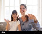 happy mother and daughter looking at webcam and wave hands t30d3h.jpg from mother daughter webcam