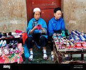 two elderly dong street vendors wearing traditional costume sell shoes bf54mw.jpg from two liping