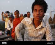 a young cambodian man enjoys the sunset view off phnom wat bakeng bmk59e.jpg from young cambodia