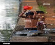 two little girls washing with canal water backwaters kerala south c638fm.jpg from desi vilage bathing dress change caught by hidden cam