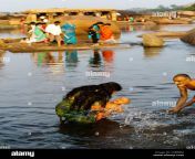 mother and father bathing their son in the tungabhadra river hampi cebebm.jpg from indian real mom son bath sexdamil