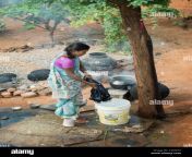 young indian woman washing clothes outside her home in a rural indian cy8hyn.jpg from indian village desi outdoor