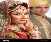 portrait of an indian bride posing with her husband in background d755k0.jpg from dulhan husband