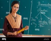portrait of young female teacher holding ruler against chalkboard ddyg10.jpg from the indian teacher and 15 sex videos