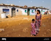 indian woman and daughter standing outside tribal village houses kalpi egj99f.jpg from indian desi vellege