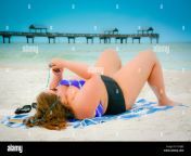 plus size woman in two piece swimsuit lying on clearwater beach fl hyhjb2.jpg from bbw bikini beach vollyball