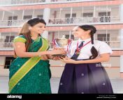 school teacher giving victory trophy girl student successful education k6p4r1.jpg from my indian school 7stand dress com