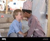 nizwa oman 10th nobember 2017 omani kid and european kid giving eachother khj1aw.jpg from omani kissing