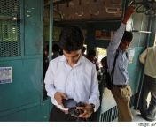man checking mobile on train india ap.jpg from kolkata new 3g