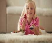 pretty little girl lying on floor eating strawberries and holding remote co vkjx8grbl thumbnail 1080 01.png from little video