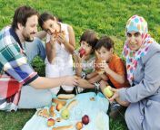 muslim family mother and father with three children together in nature sitting and eating on green grass picnic bffb0ntsj sb pm.jpg from local muslim daughter father xxx